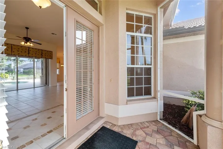 Property entrance with ceiling fan and a patio area