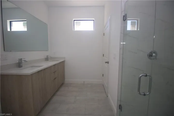 Master Bathroom featuring vanity, an enclosed shower, and a wealth of natural light
