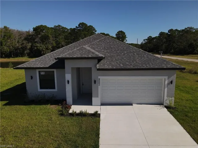 Single family house featuring a front yard and a two car garage