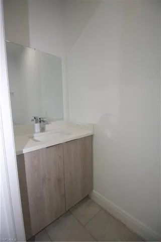 Powder Bathroom with vanity and tile patterned floors