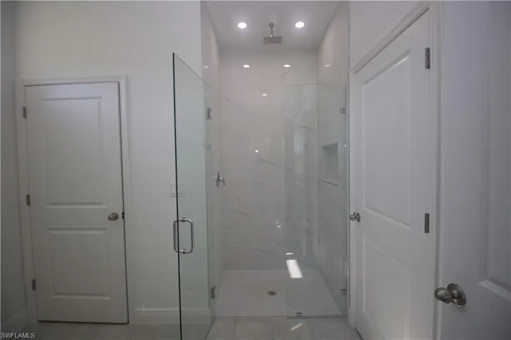 Master Bathroom featuring a shower with door
