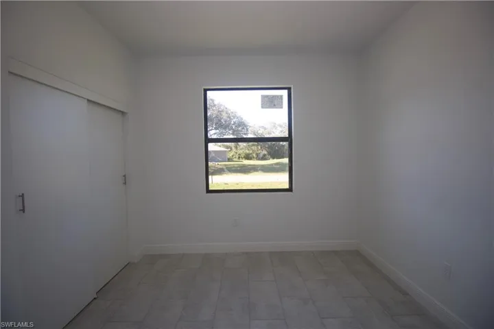 Bedroom featuring a closet and light tile patterned flooring