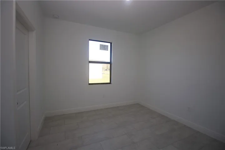 Bedroom featuring a closet and light tile patterned flooring