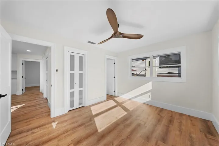 Empty room featuring light wood finished floors and ceiling fan