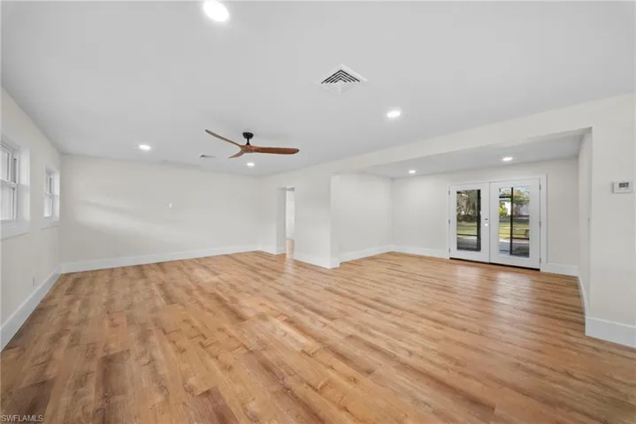 Empty room featuring french doors, plenty of natural light, light wood-type flooring, recessed lighting, and ceiling fan
