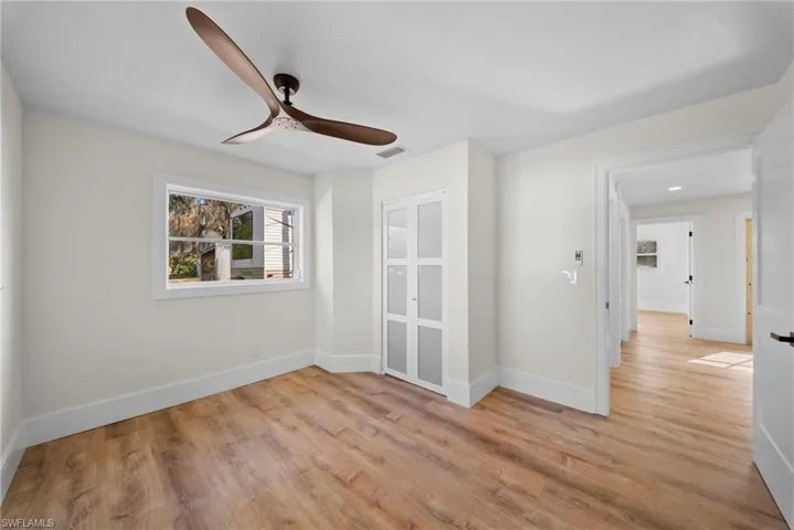 Empty room featuring light wood-type flooring and ceiling fan