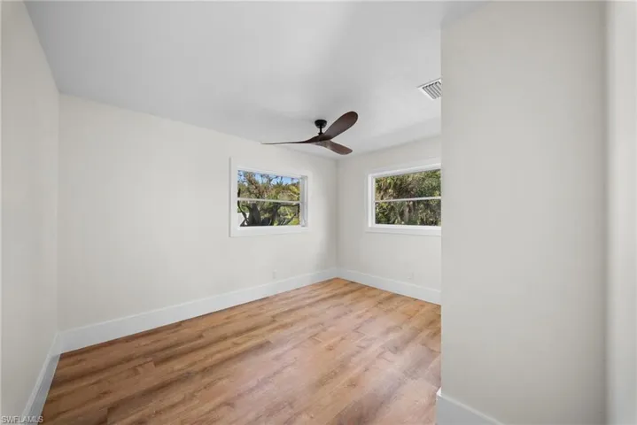 Empty room with light wood-type flooring and a ceiling fan