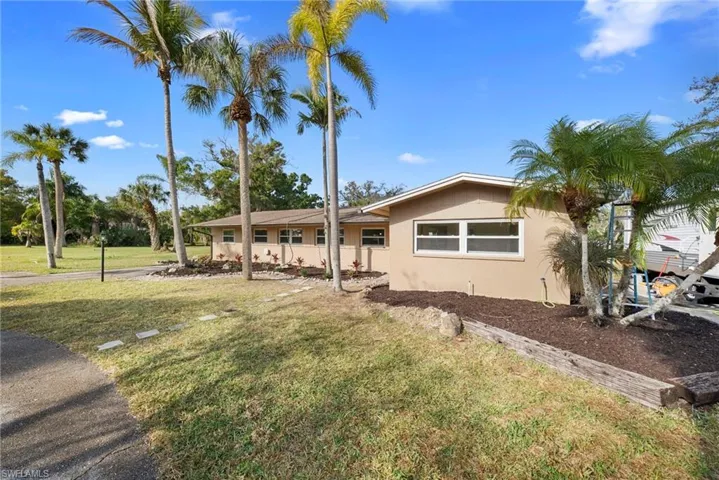 Ranch-style home featuring a front yard and stucco siding