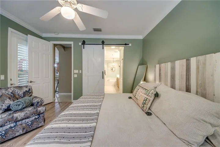 Large Main Bedroom with Barn Door, King Sized bed, and sitting area