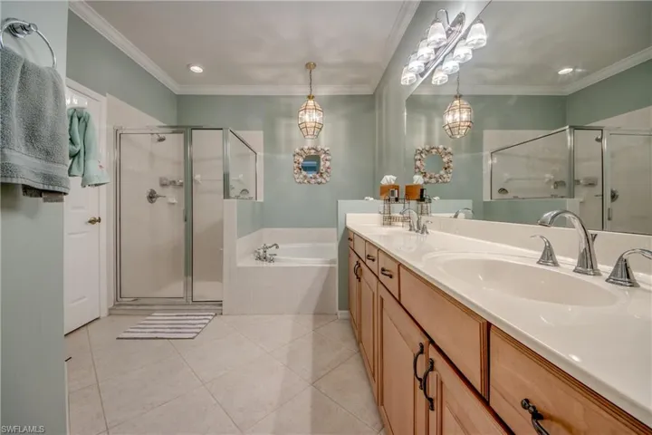 Main bathroom with dual sinks, Soaking tub, and Shower