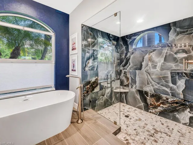 Stunning remodel! Polished tile, frameless glass, hexagon tile shower floor and free standing tub.