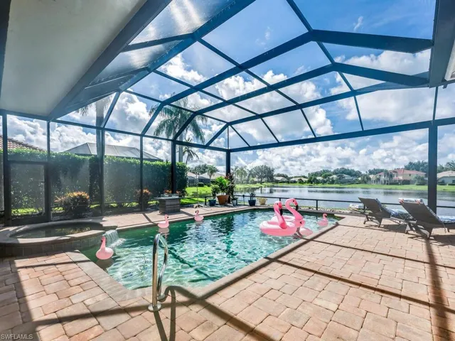 Large lanai with paver pool decking and screen enclosure with picture screen pane.