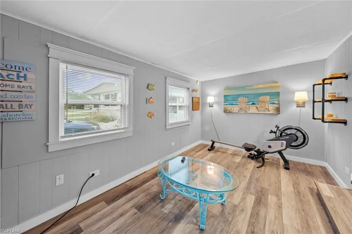 Workout area featuring hardwood / wood-style floors and ornamental molding