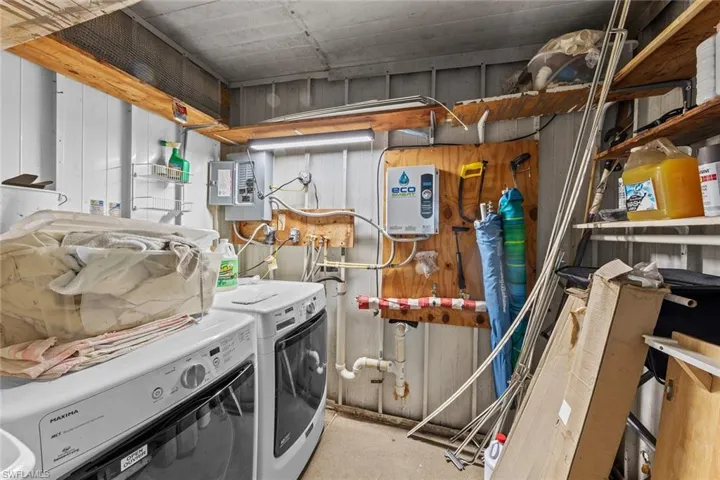 Laundry room with washing machine and dryer and electric panel