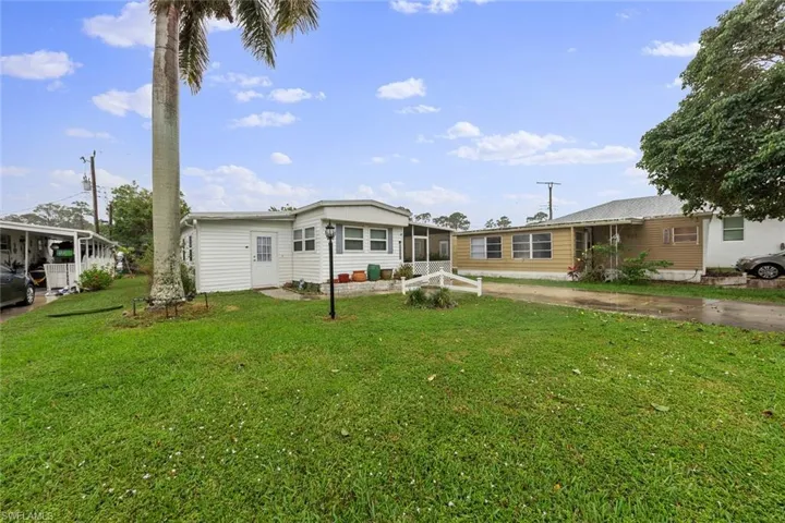 Rear view of house featuring a yard