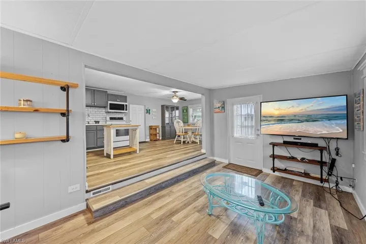 Living room featuring light hardwood / wood-style floors and ceiling fan