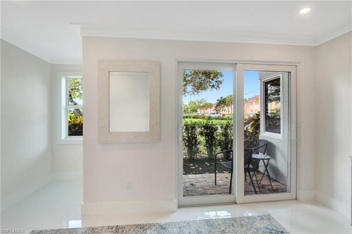 SLIDING DOORS TO PATIO AND VIEWS OF PARKLIKE SETTING