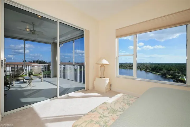 Bedroom with carpet floors and a water view