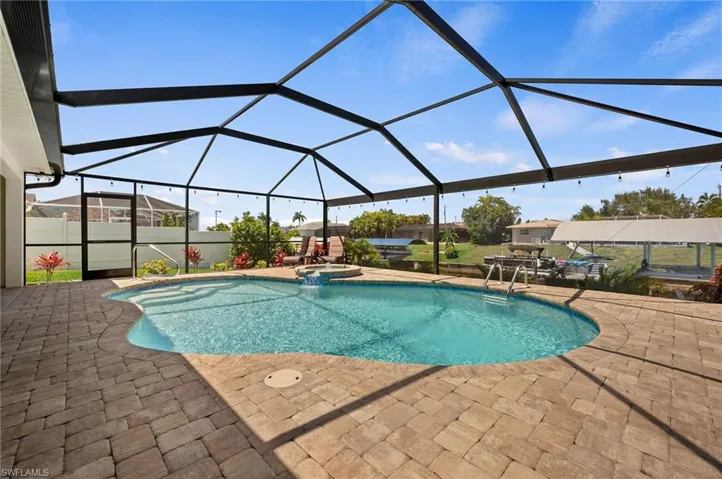 Sparkling Pool Surrounded by Brick Pavers