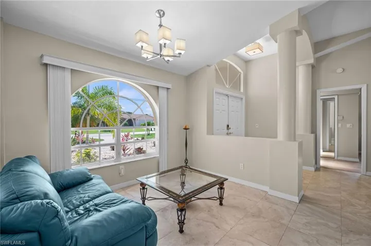 Living Room Sitting Area with Arched Window and Transom window above double doors