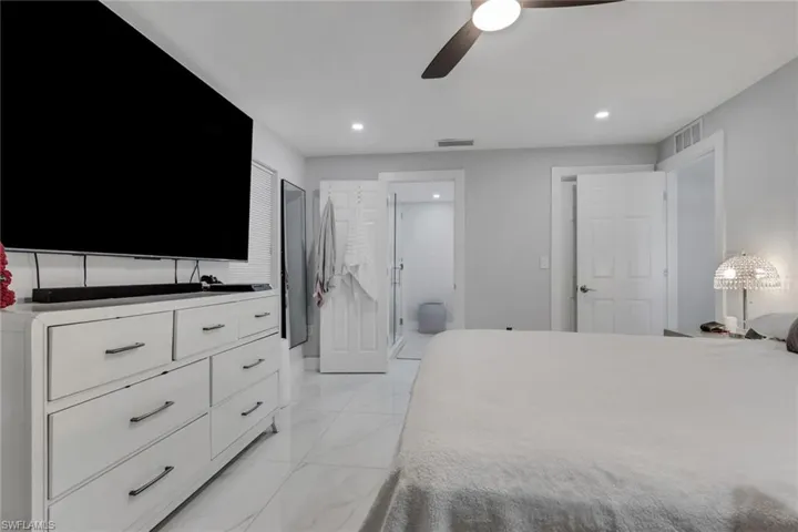 Light-toned interior featuring recessed lighting, a ceiling fan, white paneled doors, and tile flooring
