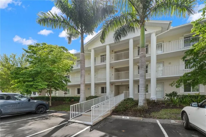 View of property with uncovered parking