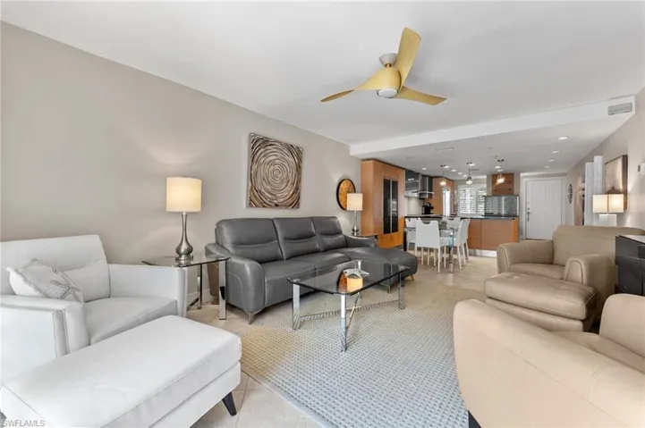Living room with light tile patterned flooring, ceiling fan, and recessed lighting