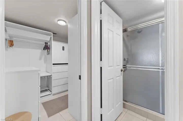 Bathroom featuring a stall shower and tile patterned flooring