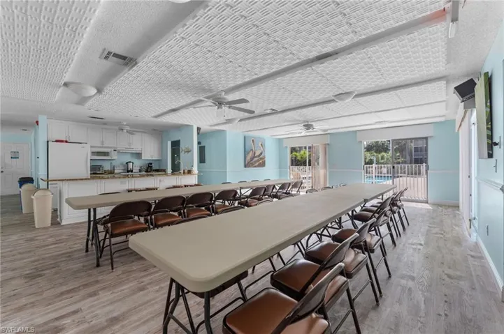Dining space with light wood-style flooring, visible vents, baseboards, and ceiling fan