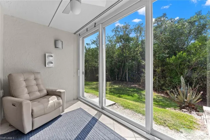 Unfurnished room with plenty of natural light, tile patterned floors, ceiling fan, and a textured wall
