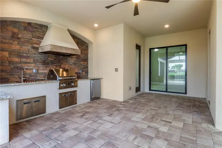 View of patio / terrace with a sink, an outdoor kitchen, grilling area, and a ceiling fan