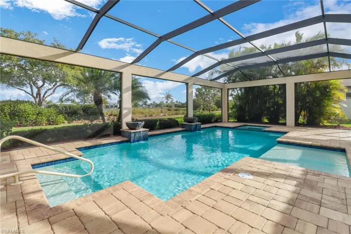 Outdoor pool with a lanai and a patio