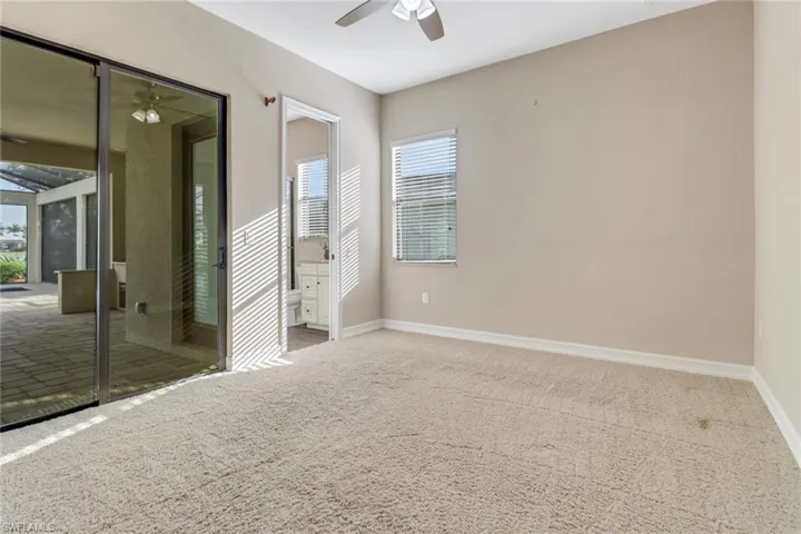 Spare room with carpet floors, a wealth of natural light, baseboards, and a ceiling fan