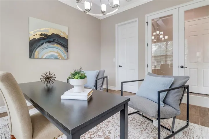 Home office or another bedroom(?)! This room features ornamental molding, and wood finished floors.