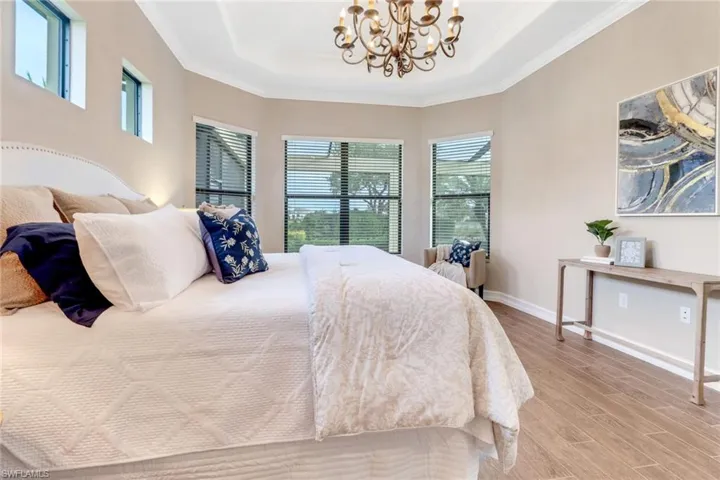 Enjoy pool views from this primary bedroom.  Two walk-in closets complete this primary bedroom suite.