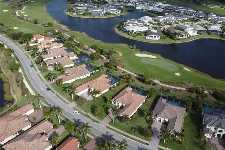 Drone / aerial view with a water view, a residential view, and golf course view