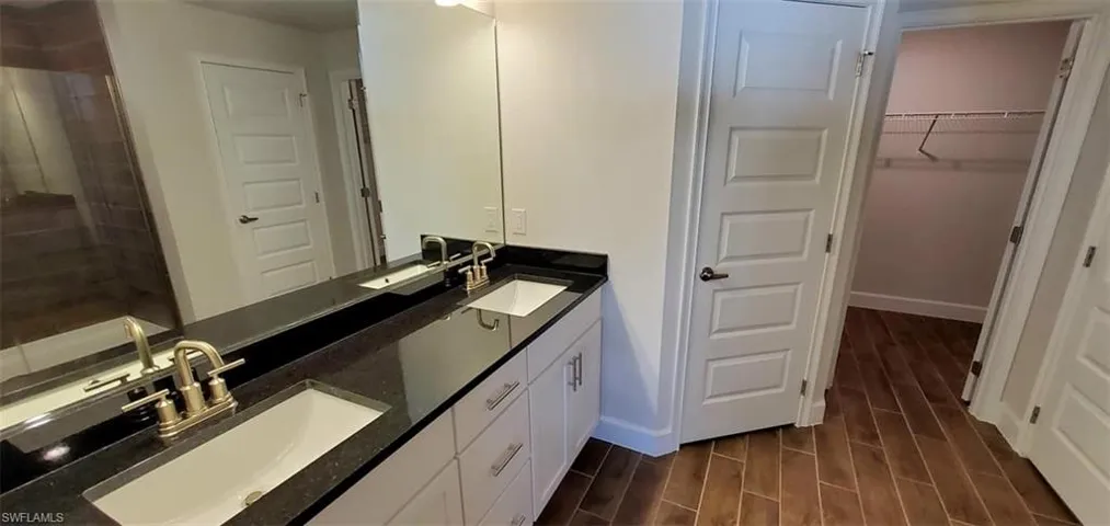 Primary Bathroom with vanity and hardwood / wood-style floors