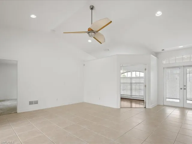 Vaulted ceilings with recessed lighting and a ceiling fan