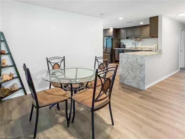 Dining area featuring light wood-style flooring and recessed lighting