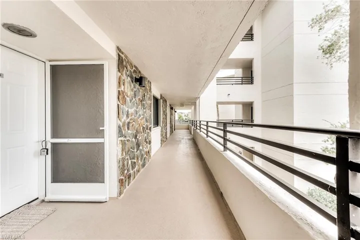Corridor featuring a textured ceiling
