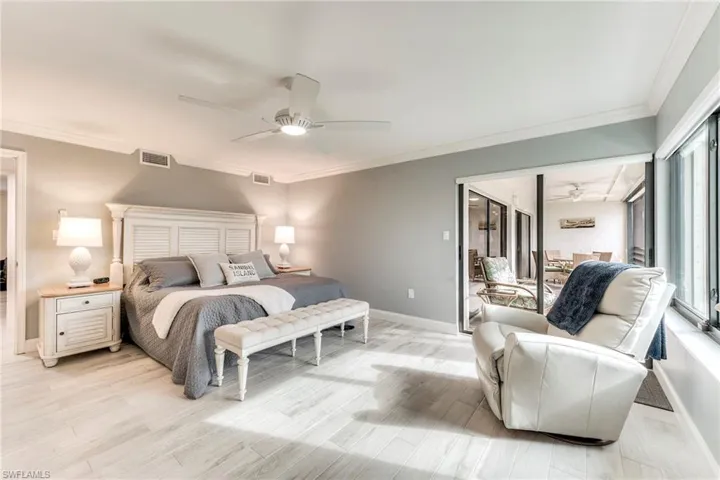 Bedroom featuring crown molding, ceiling fan, and light wood-style flooring