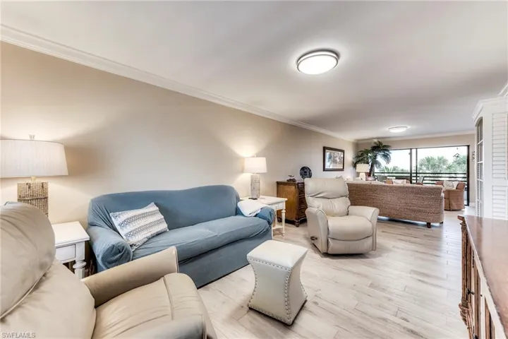 Living room featuring ornamental molding and wood finished floors