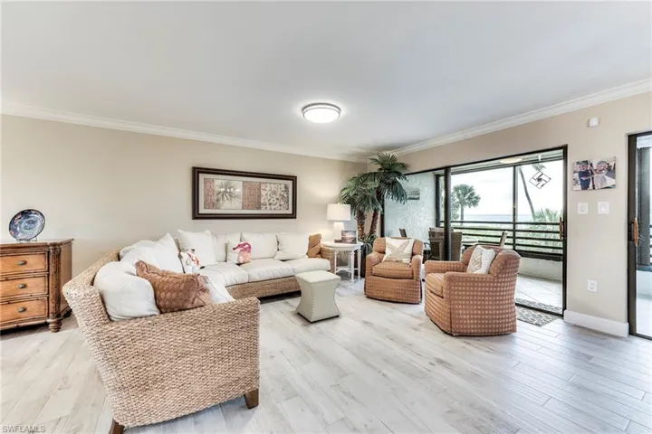 Living area featuring ornamental molding and light wood finished floors