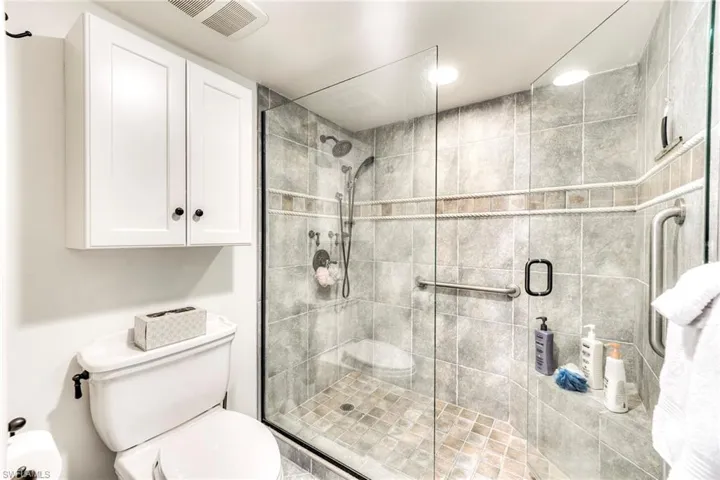 Bathroom with a stall shower and toilet