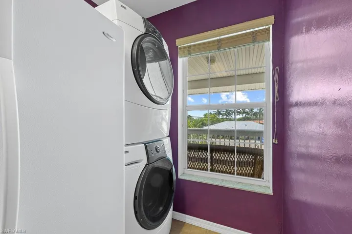 Clothes washing area featuring stacked washer / drying machine