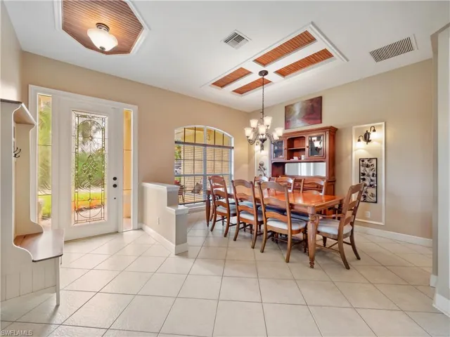 Tiled dining space featuring a chandelier