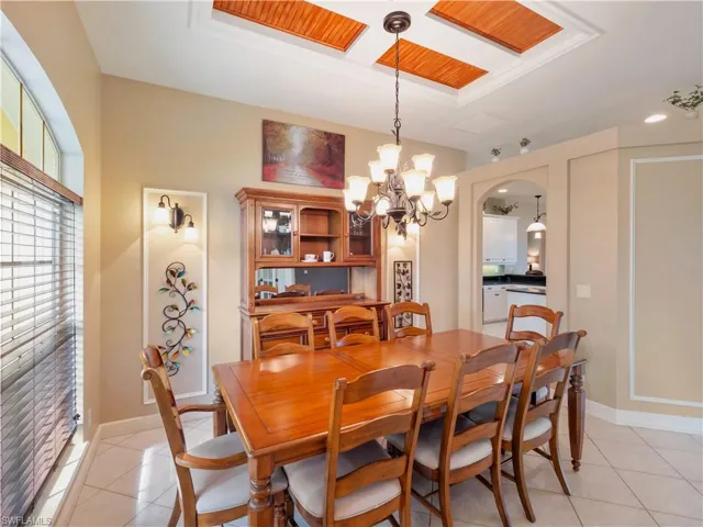Tiled dining space featuring an inviting chandelier