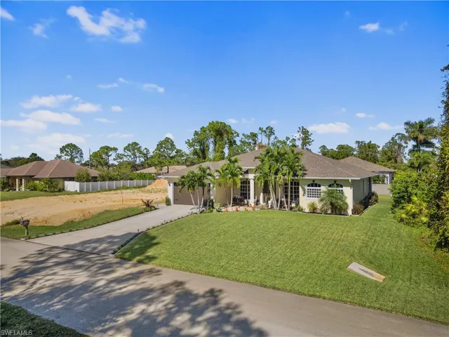 Ranch-style house with a front yard and a garage