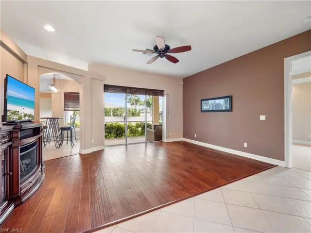 Living room featuring light hardwood / wood-style flooring and ceiling fan with notable chandelier