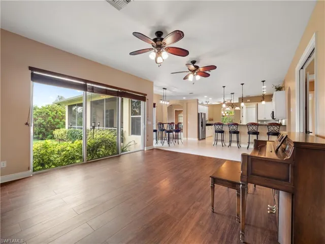 Living room with ceiling fan and wood-type flooring